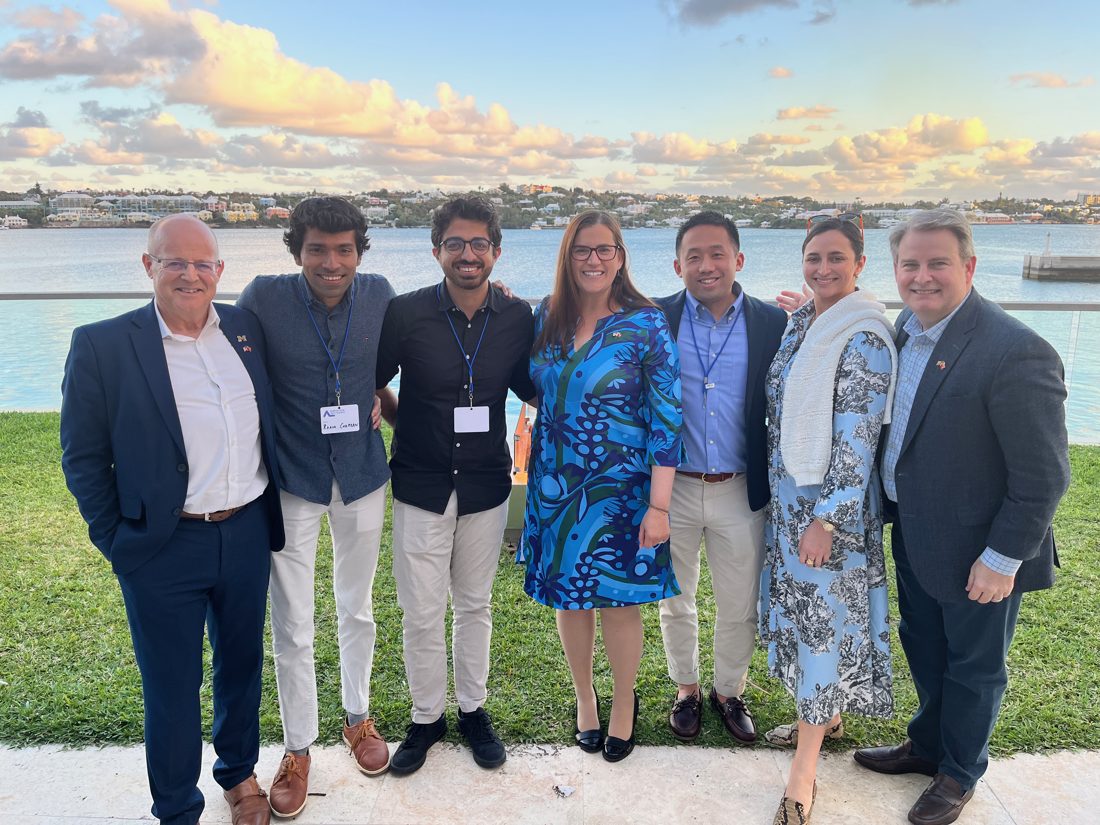 Center director, students and partners by the water at an international conference