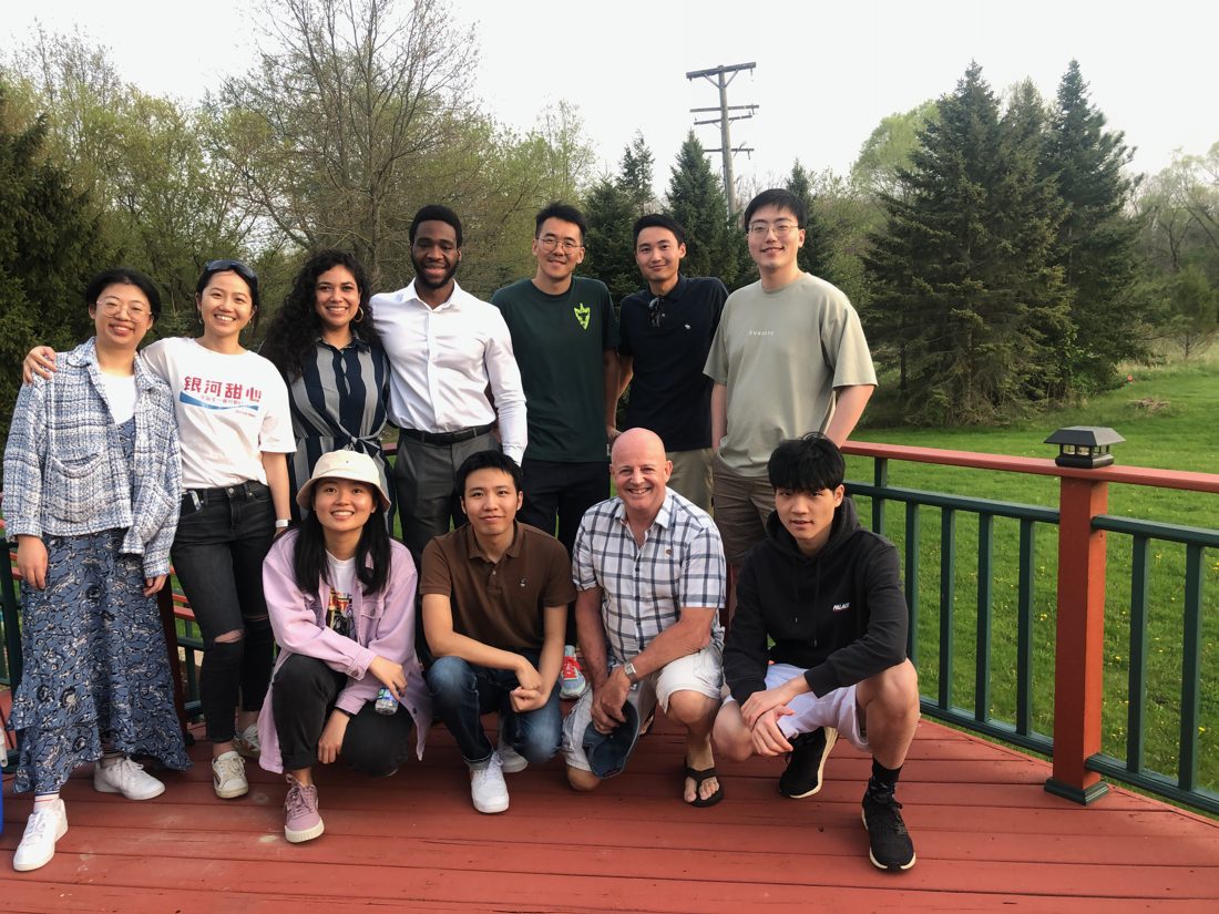 Center director with students and alumni at a spring gathering